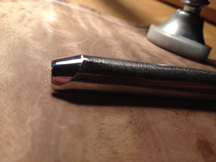 A new gouge prior to regrinding the bevel. Notice that the light rounds off the point